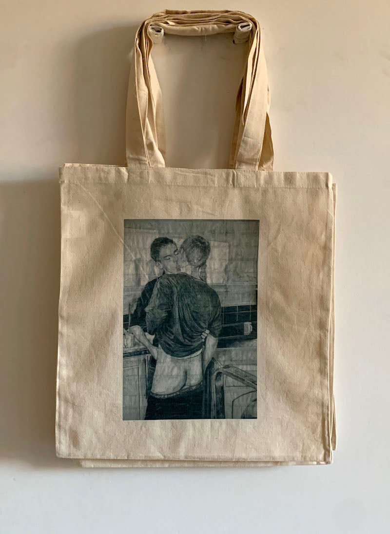 full view of a tote bag printed with an image of a drawing by the artist James Robert Morrison that depicts two men (Peter and Geoff) kissing, one of them with his bare bottom showing